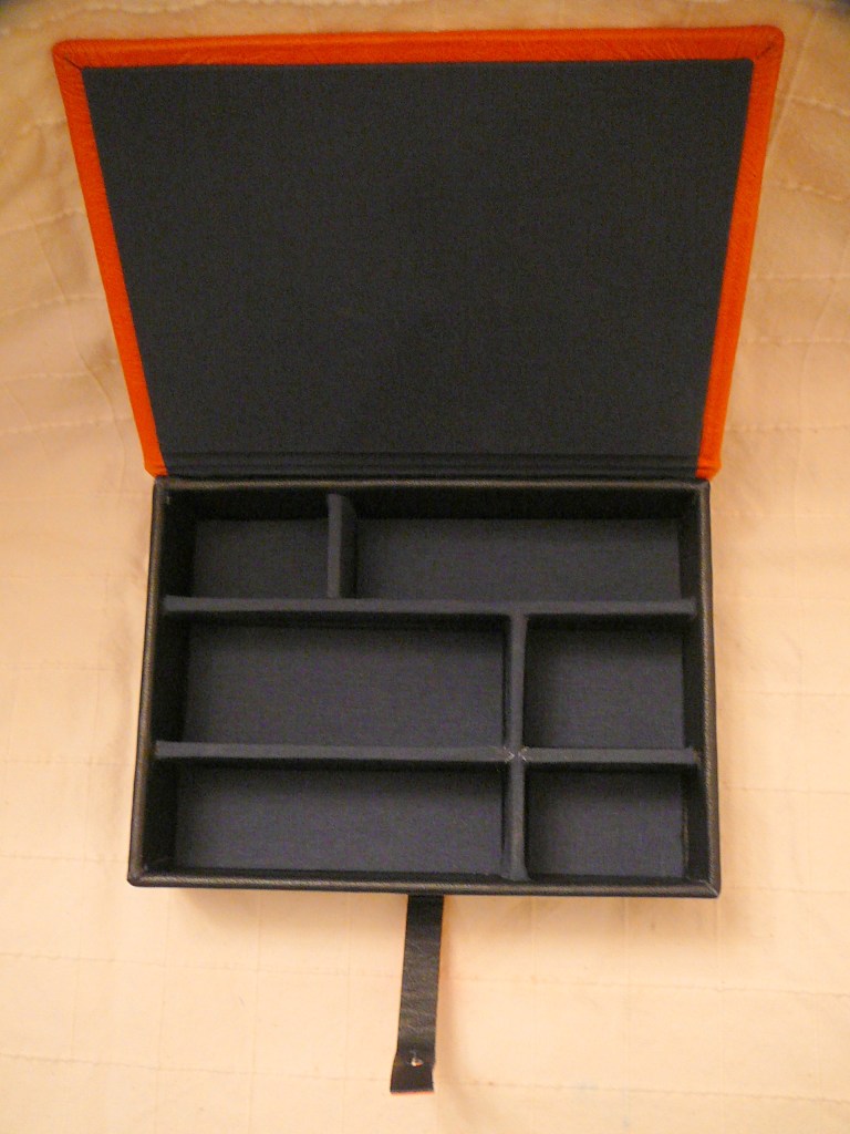 Case opens to reveal compartments lined with book cloth