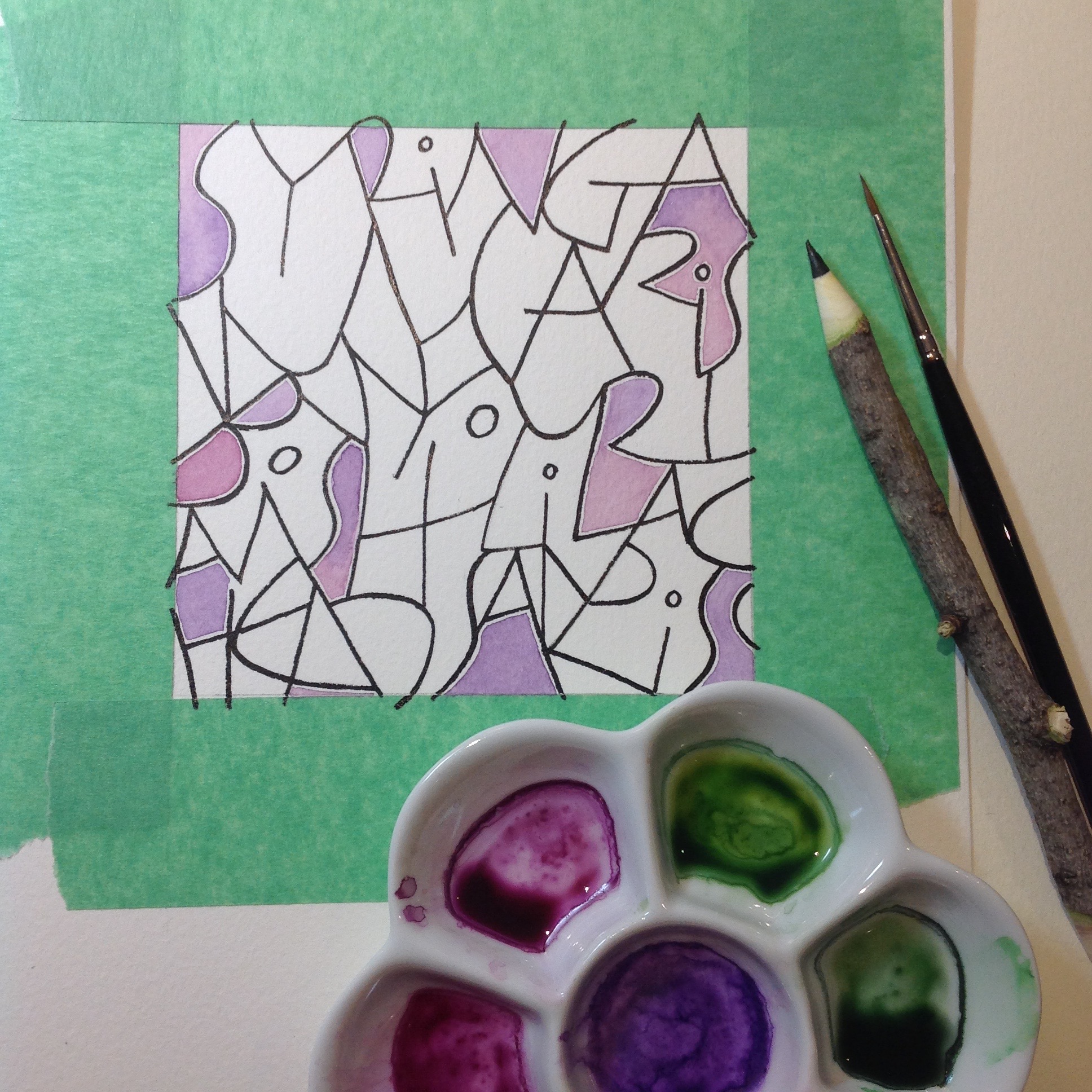 Lilac twig, pointed brush and watercolour palette.