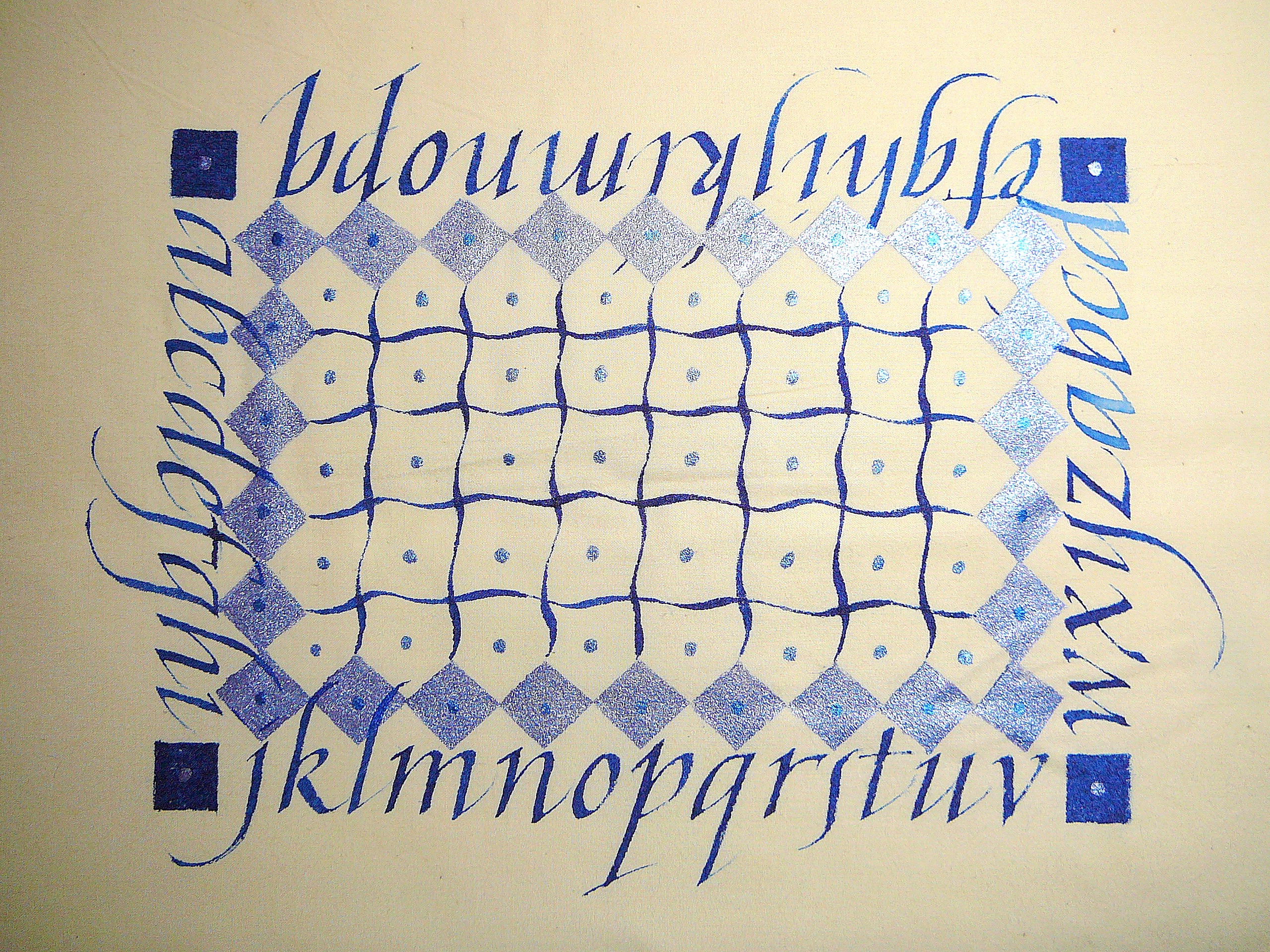 Making marks and letters on muslin using acrylic inks.